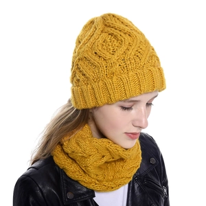 Close-up of yellow knit beanie and scarf set featuring textured wool pattern for women