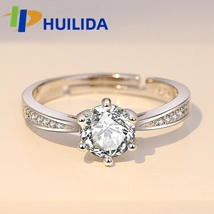 Macro shot of six-prong solitaire ring showing sparkling round cut stone and S925 hallmark