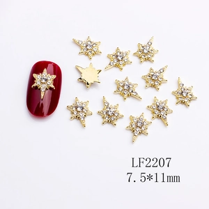 Golden sunburst nail art charms with crystal rhinestones on red nails, 7.5x11mm size