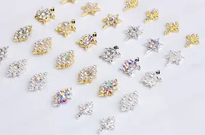 Detailed macro view of assorted gold and silver alloy nail art charms with pearls and rhinestones