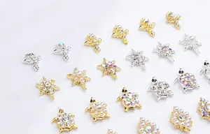 Detailed view of alloy nail art charms with golden turtles and pearl flower studs