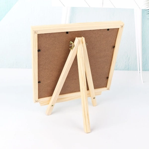 Back view of wooden frame jewelry display stand with sturdy easel and metal clips