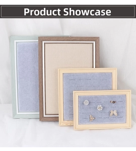 Close-up of wooden jewelry trays with grey velvet slots and beige linen lining