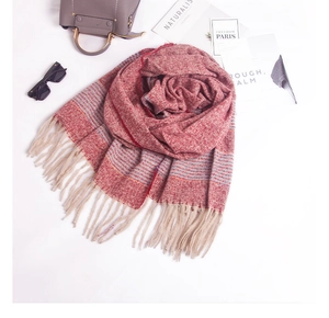 Close-up of red and grey blue striped scarf with long fringe and fashion accessories