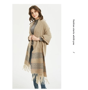 Close-up of beige pashmina scarf with fringe tassels and grey blue striped detailing
