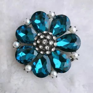 Macro detail of elegant flower brooch with blue drop crystals and small pearls