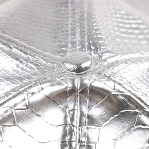 Close-up of metallic silver snake pattern PU leather baseball cap with stitching detail