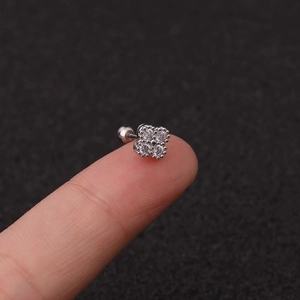 Detailed close-up of a silver stainless steel four-leaf clover stud earring with zircons