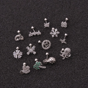 Silver flower and cactus ear studs with green zircon stones on black background