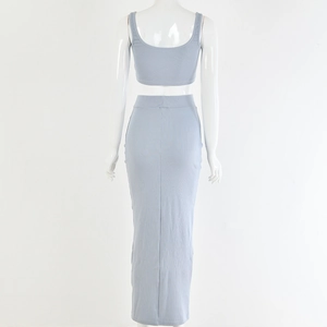 Rear view of two-piece set featuring light blue ribbed knit camisole and matching long skirt