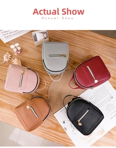 Detailed flat lay of small PU leather backpacks in pink, gray, red, tan, and black colors