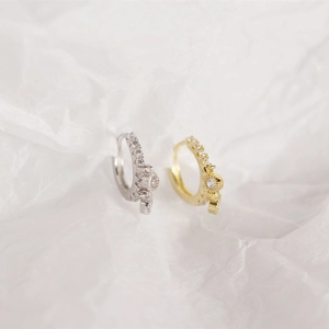 Macro shot of silver and gold plated sterling silver hoop earrings with pave diamonds