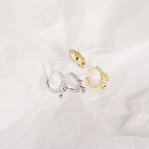 Close-up of three pairs of S925 sterling silver hoop earrings with inset crystals