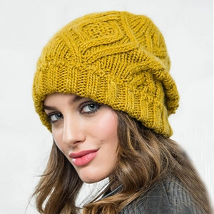Macro shot of ginger yellow knit headband showing chunky cable weave texture and details