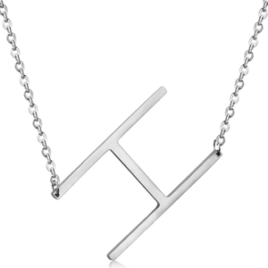 Macro detail of a silver stylized letter H pendant on a polished stainless steel chain