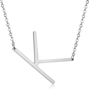 Detailed close-up of a silver letter K pendant on a polished stainless steel chain