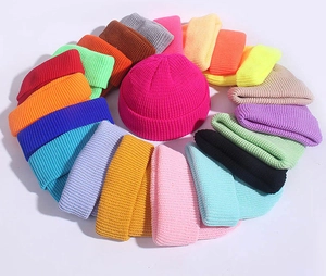 Colorful knitted beanies displayed in a vibrant circular layout on a clean background