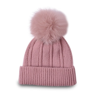 Pink knitted beanie featuring a large fluffy faux fur pom-pom and thick ribbed texture