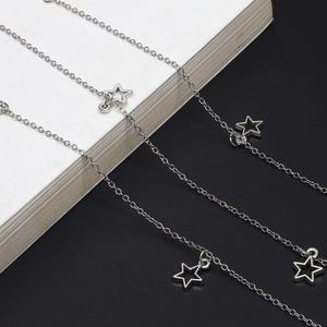 Detail shot of silver metal sunglasses chain featuring hollow star pendant charms