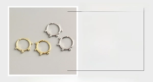 Detailed macro view of S925 sterling silver beaded hoop earrings in gold and silver finishes