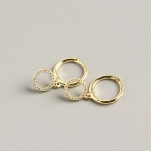 Detail shot of gold-plated s925 silver hoop earrings with sparkling zircon round charms