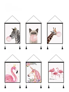 Detail view of animal wall tapestries with pink bubble motifs and black tassels