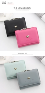 Detail view of four tri-fold wallets with heart metal accents and snap kiss-lock closures