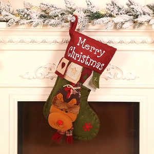 Linen Christmas stocking with 3D reindeer decor hanging on fireplace mantel with warm lights