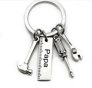 Detail of silver tool charms with Papa engraving and ruler on stainless steel keychain