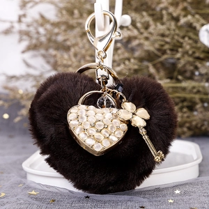 Brown plush heart keychain with cat eye stone pendant and gold clover charm accessories