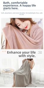 Close-up of soft waffle weave absorbent bath towels in pink and grey showing plush texture
