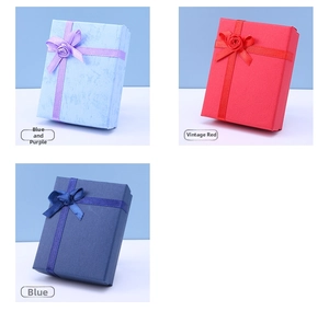 Detail of ribbon bows and decorative roses on textured cardboard jewelry gift boxes