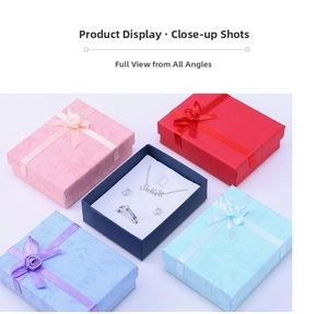 Macro view of assorted marble pattern jewelry gift boxes with satin bows and sponge inserts