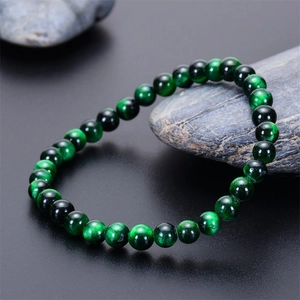 Macro shot of green tiger eye beaded bracelet showing silk luster and chatoyancy effect