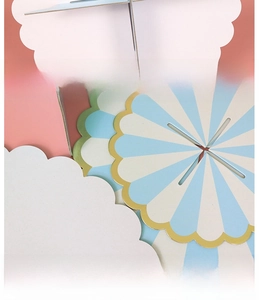 Detailed close-up of sky blue and white striped paper cake stand with gold scalloped edges