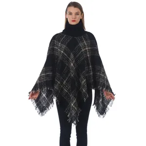 Women's turtleneck plaid poncho sweater with classic black and white grid and fringe trim