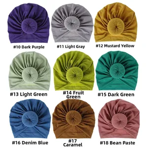 Grid display of soft donut turban headwraps available in nine different vibrant colors.