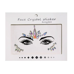 Macro detail of holographic face crystal stickers with luminous glow on white packaging