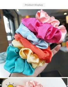 Detail of colorful satin silk scrunchies set featuring soft pleats and glossy fabric texture