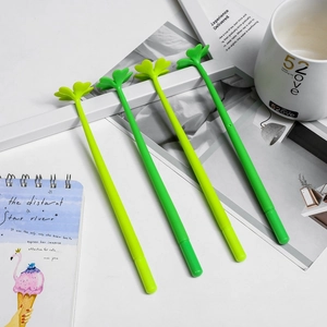 Creative four-leaf clover gel pens set on an aesthetic notebook and coffee mug workspace