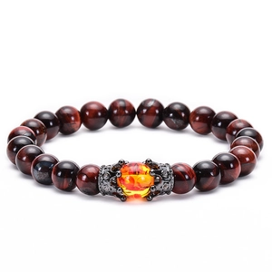Detail of tiger eye bracelet featuring crown spacers and amber central bead