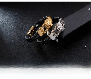 Detailed close-up of retro lion head buckle on braided leather bracelet for men