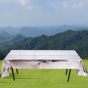 Detailed view of silver metallic foil tablecloth for party decoration on outdoor table