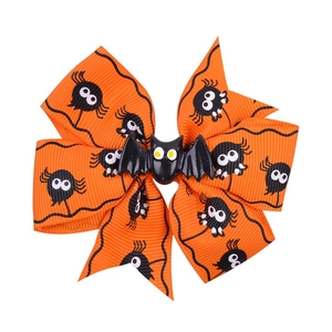 Halloween hair bow with orange spider web patterns and a black 3D bat center