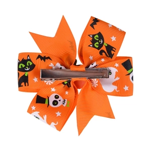 Orange Halloween hair clip with black cat and ghost patterns on ribbed ribbon metal clip