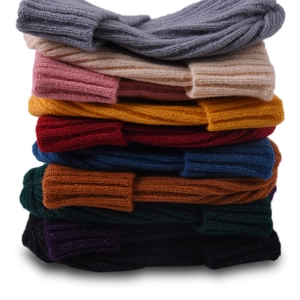 Vertical stack of ribbed knit beanies for kids in multiple vibrant colors and soft texture