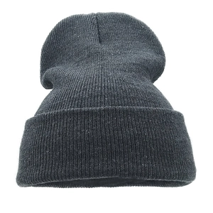 Detailed close-up of black knit beanie showing thick acrylic texture and folded cuff style