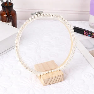 Round embroidery hoop with pearls and wood base for jewelry display or home decor