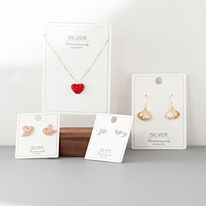 S925 sterling silver jewelry set featuring heart pendants and earrings on display cards