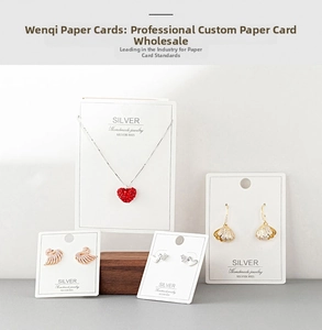 Detail of white jewelry display cards featuring various stud earrings and necklaces